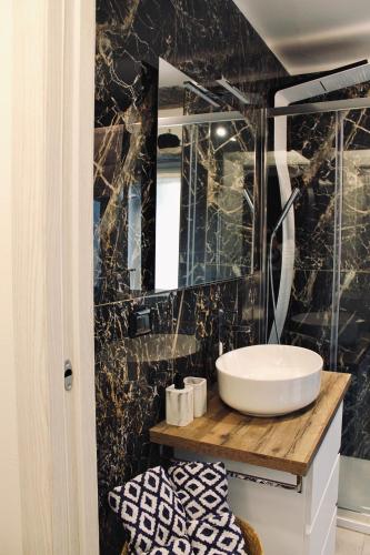 a bathroom with a sink and a mirror at Kiko's Lodge - Historical Apartment in Como in Como