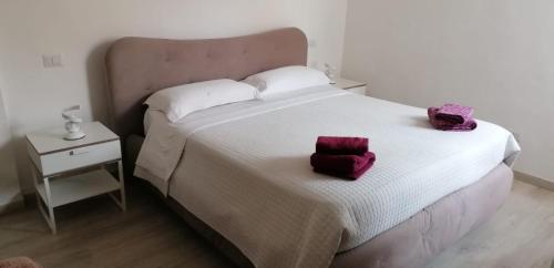 a bedroom with a large bed with two bags on it at Casa Marina in Foligno
