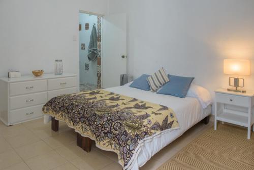 a bedroom with a bed and a dresser and a mirror at Charming House at Roma in Mexico City