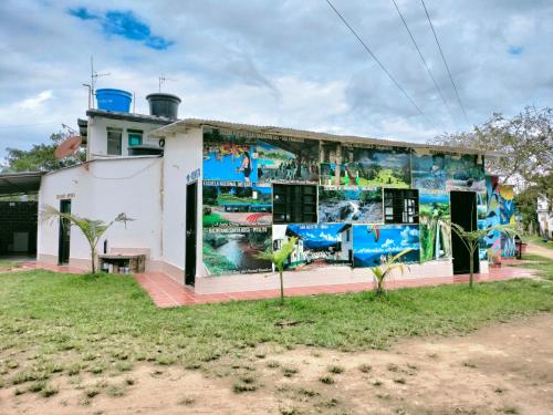 a building with a mural on the side of it at Hotel Yamboró in Pitalito