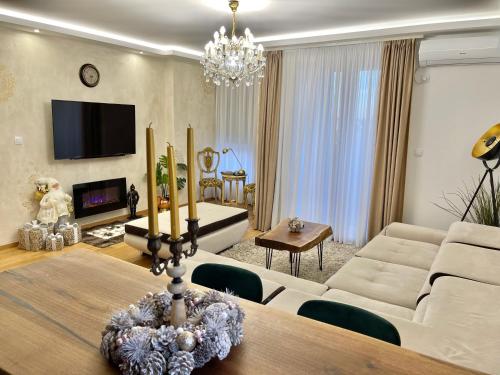 a living room with a dining table and a living room with at Plaza extra lux apartman garage free in Stanovo