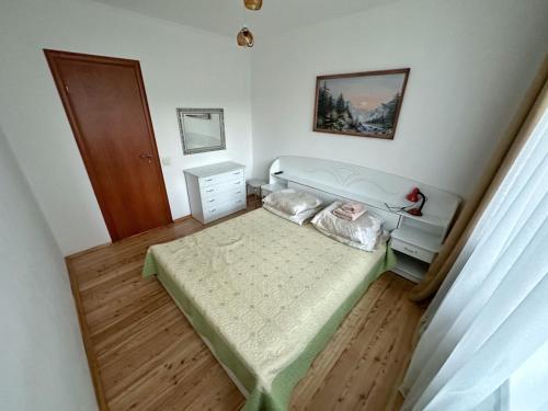 a small bedroom with a bed and a dresser at Magnolia Truskavets in Truskavets