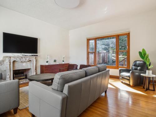 a living room with a couch and a tv at Coastal Serene Retreat in the Heart of Monterey! home in Monterey
