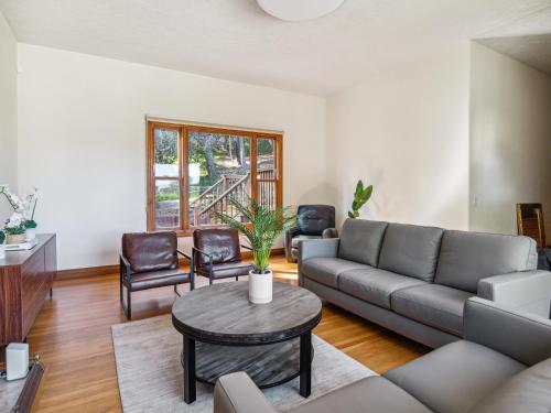 a living room with a couch and a table at Coastal Serene Retreat in the Heart of Monterey! home in Monterey