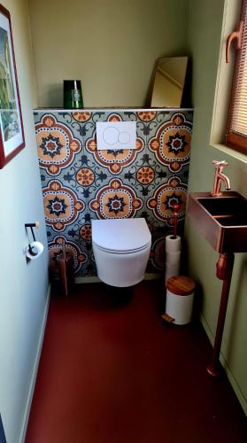 a bathroom with a toilet and a sink at Wellness op'e Klaai in Holwerd