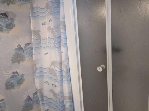 a door with a shower curtain in a room at Le nid in La Bourboule