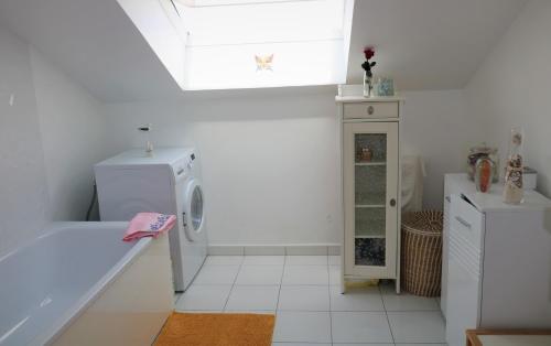 a white bathroom with a washing machine and a sink at Lovely flat close Paris Disney. in Neuilly-sur-Marne