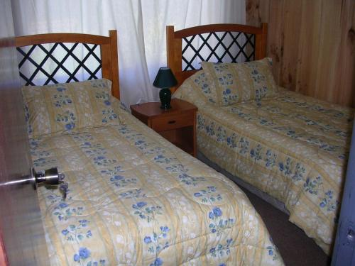 two beds sitting next to each other in a bedroom at A&O Courmayeur in Courmayeur