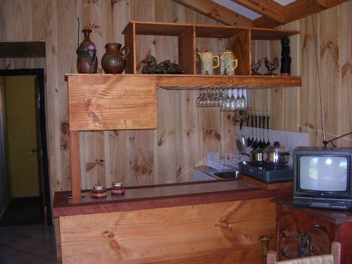 a kitchen with a counter and a tv in a room at A&O Courmayeur in Courmayeur