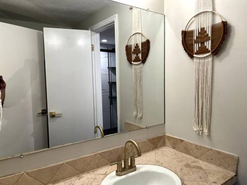 ein Bad mit einem Waschbecken und einem Spiegel in der Unterkunft Park City Southwestern Bunker in Park City