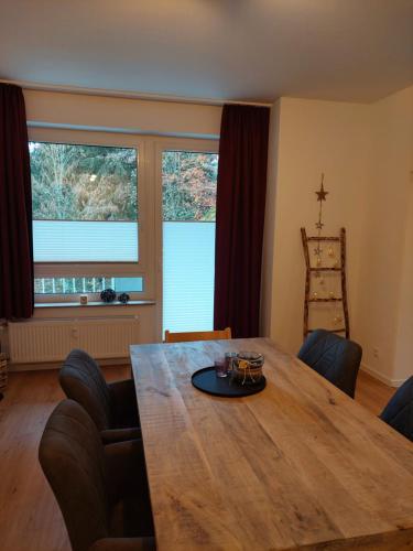 a dining room with a wooden table and chairs at Bocksberg-Lodge in Goslar