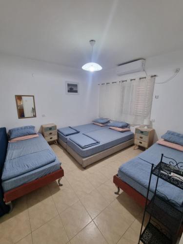 a bedroom with two beds in a room at Nadia Hosting Dead Sea in Neve Zohar