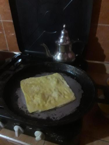 a pan with a piece of food in it at ECOLODGE MISS ROSE CHEZ LA FAMILLE in Boumalne