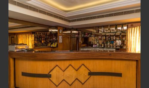 a bar in a restaurant with a bar counter at Hotel Sri Ram Residency in Udupi