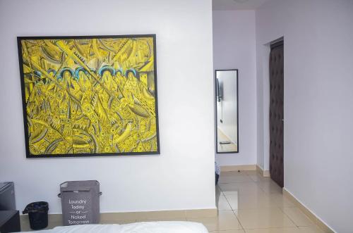 a painting hanging on a wall in a room at Guided Hospitality - Luxury Accommodations in Lagos