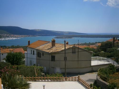 a house with a view of a body of water at Apartments Luce in Kornić