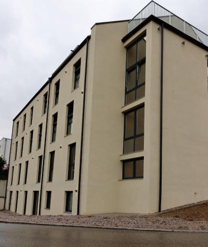a white building with windows on the side of it at Hotel Wehra in Wehr