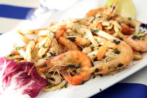 a plate of food with shrimp and other foods at Rome Palace Deluxe - All Inclusive Premium in Sunny Beach