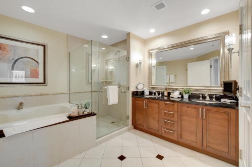 a bathroom with a tub and a sink and a shower at Blu Cashmere Suite * MGM Signature 23rd FLR w/balcony strip view in Las Vegas