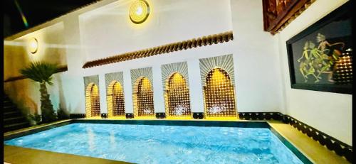 a large swimming pool in a room with at Dar Najat in Marrakech
