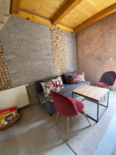 a living room with a couch and a table at Apartmani Snježna Kraljica Vlašić 1 in Vlasic