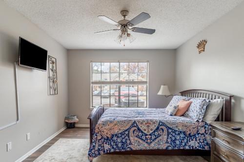 a bedroom with a bed and a ceiling fan at Heart of Huntsville in Huntsville