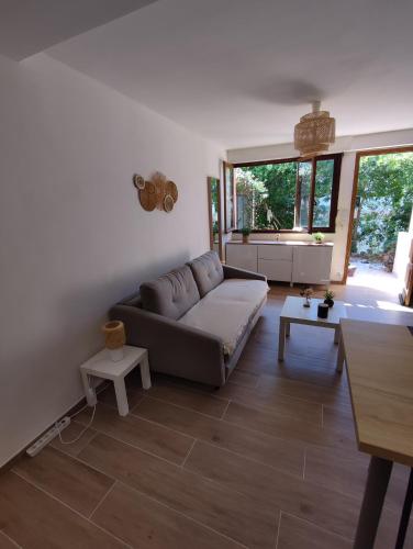un salon avec un canapé et une table dans l'établissement Charmant Studio Lavandou - 500m plage, au Lavandou