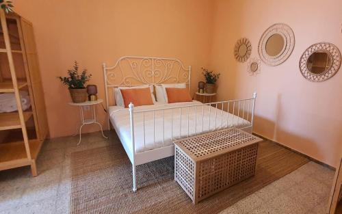 a room with a white bed with pillows on it at Puerto Mogan Casa Feliz in Puerto de Mogán