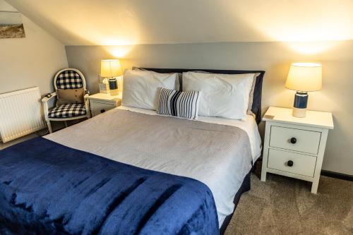 a bedroom with a large bed with a blue blanket at Loft apartment in Accrington Stunning Lancashire views in Church