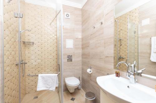 a bathroom with a shower and a toilet and a sink at Rome Palace Deluxe - All Inclusive Premium in Sunny Beach