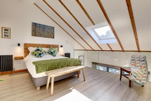 a bedroom with a bed and a skylight at The Owl Barn Wiltshire - Slate in Swindon