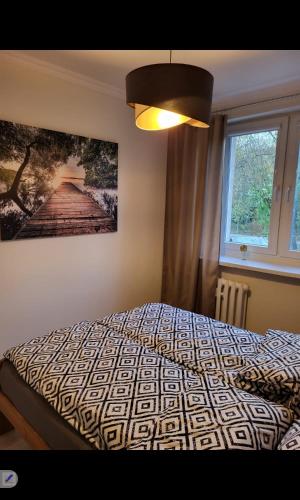 a bedroom with a bed with a picture on the wall at Apartament Przemyślany in Przemyśl