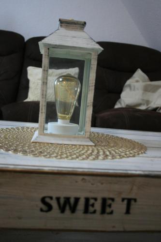 a candle in a lantern on a coffee table at Ferien Oase am BER in Schönefeld