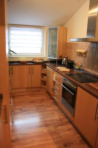 a kitchen with a sink and a stove top oven at Ferien Oase am BER in Schönefeld