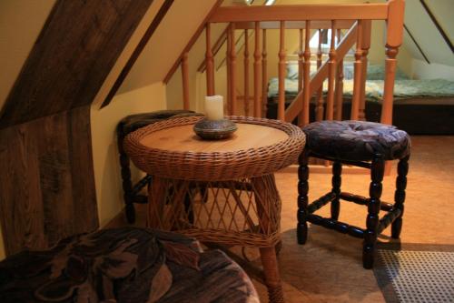 a small table with a candle on it next to a staircase at Ferien Oase am BER in Schönefeld