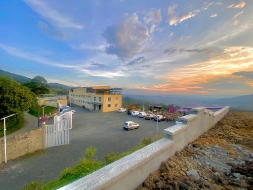 a view of a parking lot with cars in a parking lot at Hotel Entre Lomas in Santa Rosa de Cabal