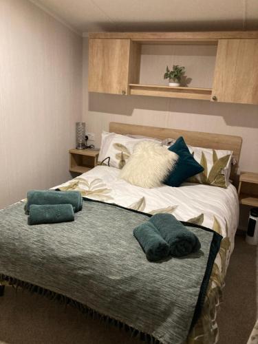a bedroom with a bed with two pillows on it at Sunflower Lodge, Lido Leisure Park, Knaresborough in Knaresborough