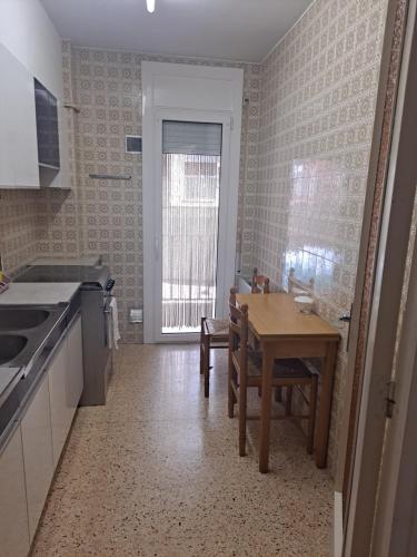 a kitchen with a table and a dining room at Apartamento CANYET in Berga