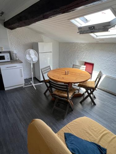 a room with a table and chairs and a kitchen at Appartement centre ville de Carcassonne in Carcassonne