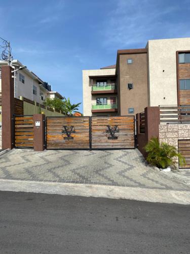 a wooden fence in front of a building at Victory Luxury Apartments in Montego Bay