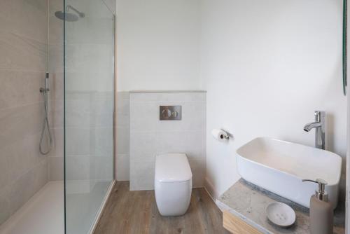 La salle de bains est pourvue de toilettes, d'un lavabo et d'une douche. dans l'établissement Luxury Converted Water Tower In Yorkshire, à Emley