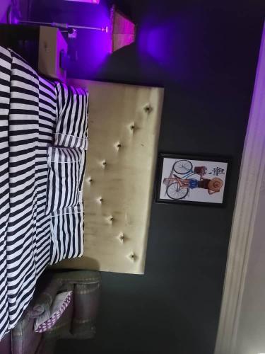 a bedroom with a wall with a shelf with a bike on it at Eunique Residence in Port Harcourt