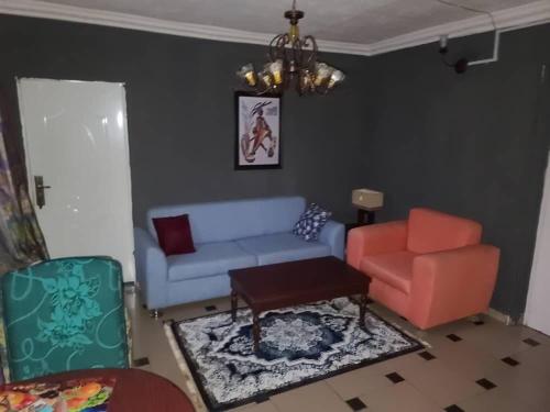 a living room with a couch and a chair at Eunique Residence in Port Harcourt