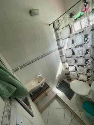 a small bathroom with a toilet and a sink at Renan suítes in Arraial do Cabo