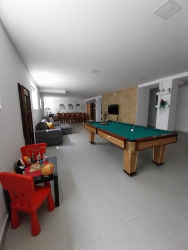 a living room with a pool table in it at Al Santiago T2 in Castelo do Neiva