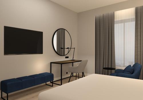a hotel room with a bed and a desk and a mirror at Radisson Blu Hotel, Amman Galleria Mall in Amman