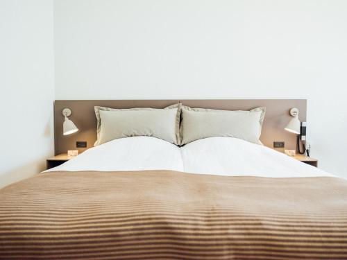 Postel nebo postele na pokoji v ubytování Hotel Føroyar