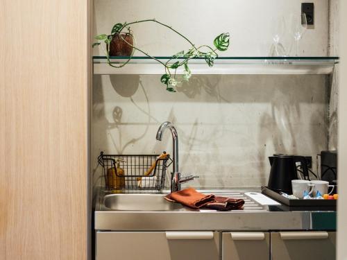 a kitchen counter with a sink and a sink at Hotel Føroyar in Tórshavn