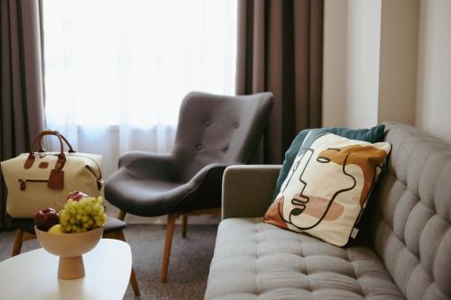 a living room with a couch and two chairs at LOCATION in Sofia