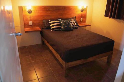 1 dormitorio con 1 cama con 2 almohadas en El Rincón de Petunio en Sayula
